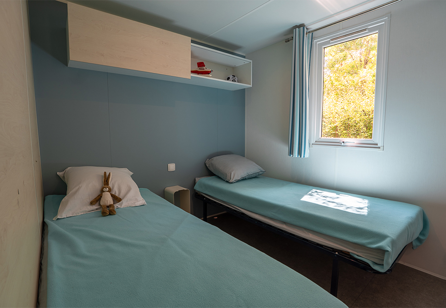 La terrasse couverte équipée de transats, du mobil-home Premium + 4 personnes 2 chambres, dans le Tarn, du camping 4 étoiles le Chêne Vert près de Gaillac